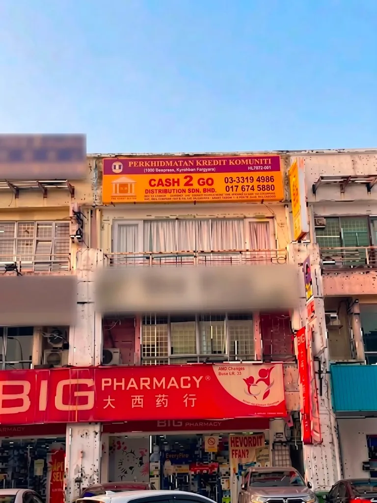 Cash 2 Go Distribution licensed moneylender branch storefront with orange signboard in Bukit Tinggi, Klang, Selangor, located on the second floor above Big Pharmacy